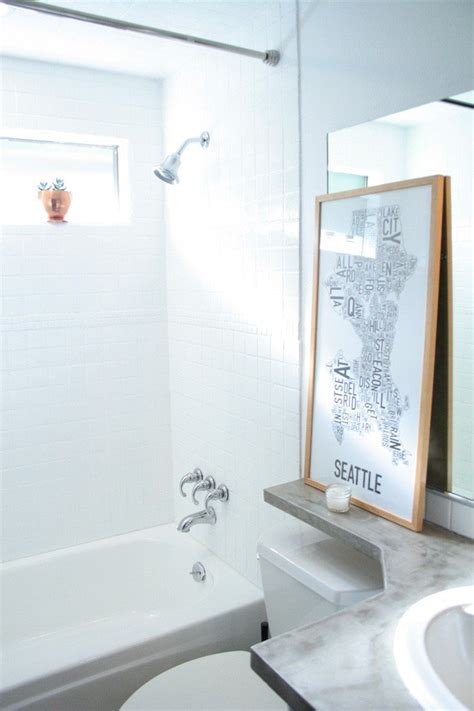 Surface preparation entails sanding vacuuming and then scrubbing the tile and grout lines. How to Paint Shower Tiles White | A Budget Remodel Option!