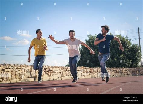 3 Men Running Outside Stock Photo Alamy