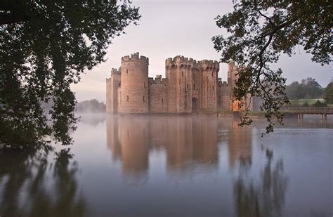 Stunning Moat And Castle In Autumn Fall Sunrise With Mist Over M