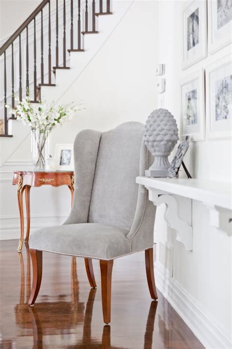 There is a sort of laminate wall surface with a mounted mirror and black drawer's. Gray Velvet Wingback Chair - Transitional - entrance/foyer ...