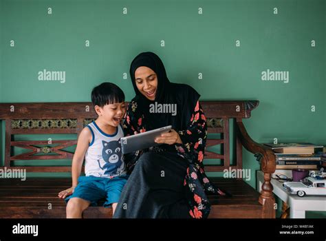 Asian Mother And Son Playing Games On Smart Stock Photo Alamy