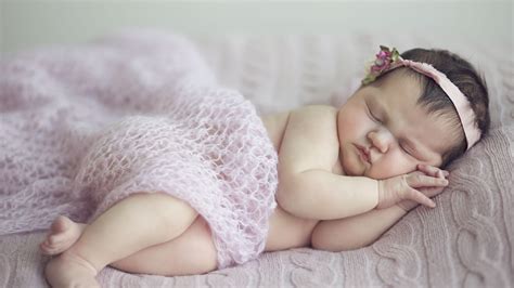 Cute Baby Girl Is Sleeping On Bed Covered With Netted Cloth And Having