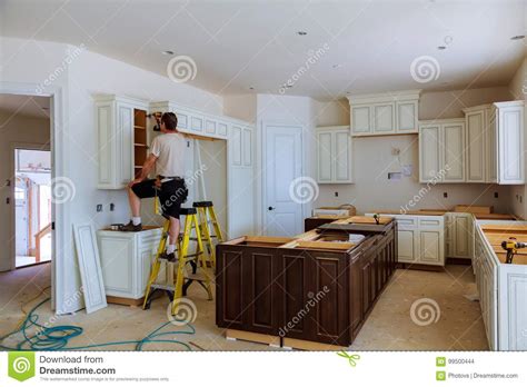 Measure the height of the base cabinets. Installation Of Kitchen Cabinet. Stock Photo - Image of ...