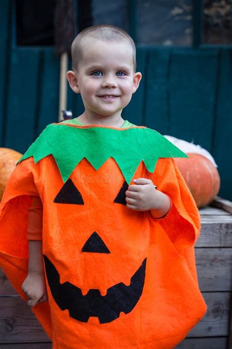 A Boy In A Pumpkin Costume Stock Image Image Of Outdoors Rustic