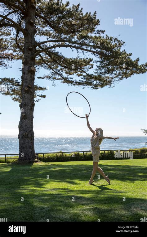 usa california big sur esalen hula hooping on the lawn by the lodge in front of the pacific