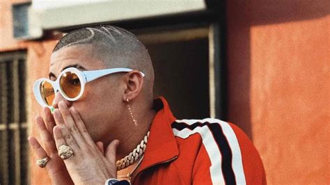 Cool Bad Bunny Aesthetic Is Having Hands On Mouth Wearing Orange Shirt