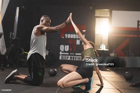Woman And Man Friends High Fiving Exercise While Planking On A Fitness