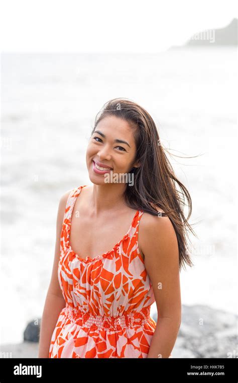 Lifestyle Portrait Of An Attractive Hawaiian Woman Wearing A Flower