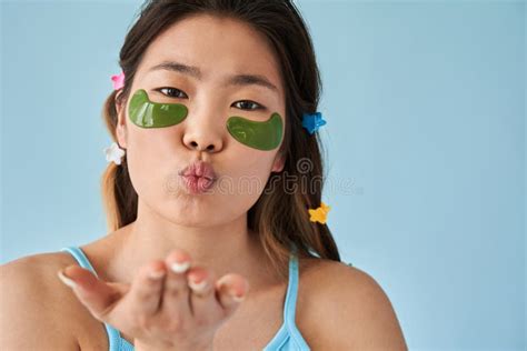 Woman With Green Under Eye Patches Sending Air Kiss To The Camera While Posing Stock Image
