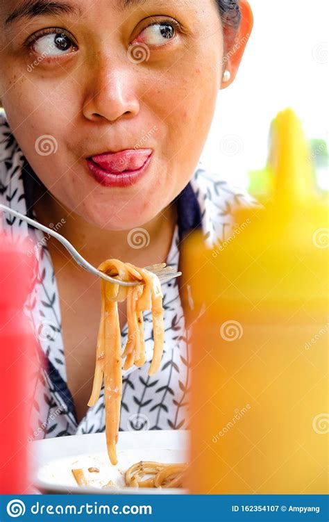 Facial Expression Of An Asian Adult Woman Who Really Enjoy Eating