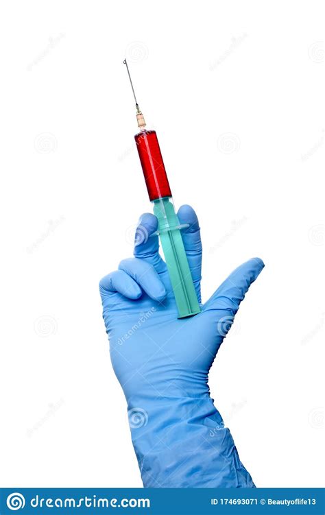 Closeup Of Syringe Filled With Blood In Doctors Hand Isolated On White