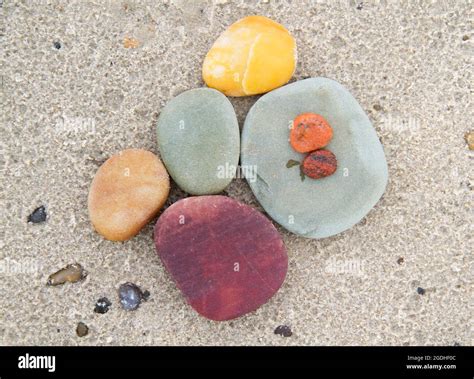 Multi Colored Pebbles On The Sand Of A Beach Stock Photo Alamy