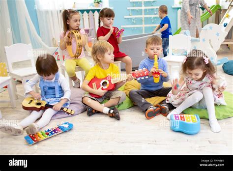 Kids Learning Musical Instruments On Lesson In Kindergarten Or