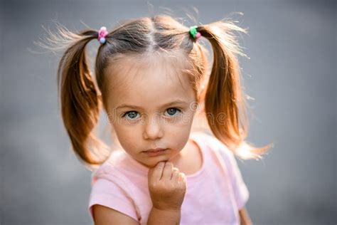 Portrait Of Beautiful Little Girl With Blue Eyes And Blond Hair Stock