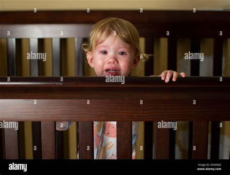 Caucasian Baby Girl Crying In The Crib Sad Sick Child Stock Photo Alamy