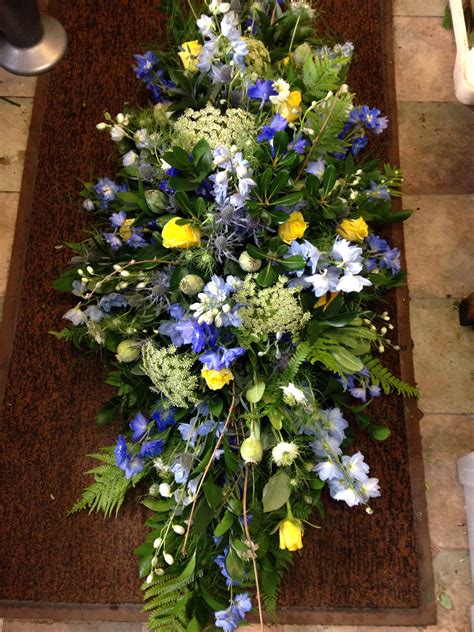Adorning the casket with beautiful. Natural casket spray of mixed foliages,delphinium,nigella ...