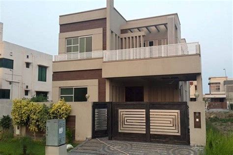 Main entrance door of this three bedroom bungalow house design is wood panel door and arched steel window. What is a typical upper middle class household in Pakistan ...