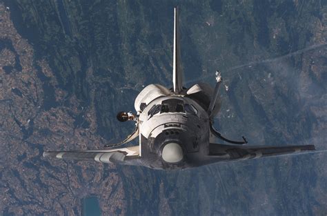 Nasas Space Shuttle Discovery Sts 114 Backdropped By The Jura