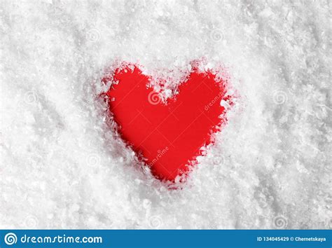 Heart Shaped Silhouette In Decorative Snow On Color Background Stock