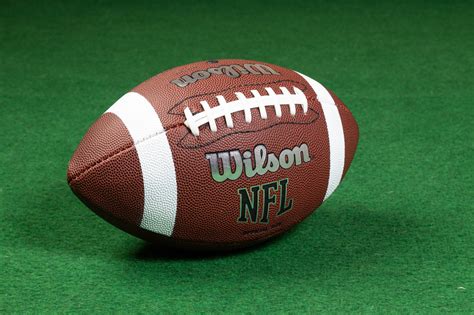 American Football Ball On Grass Pledge Sports
