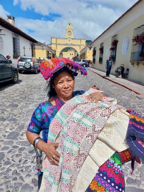 Cheerful Mayan Indian Woman Wearing A Traditional Huipil Sells