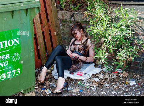 Drunk Girl Passed Out By Bins Stock Photo Alamy