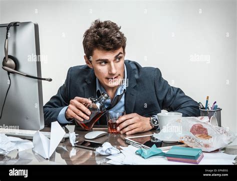 Drunk Businessman Sitting Drunk At Office With Computer Holding Glass