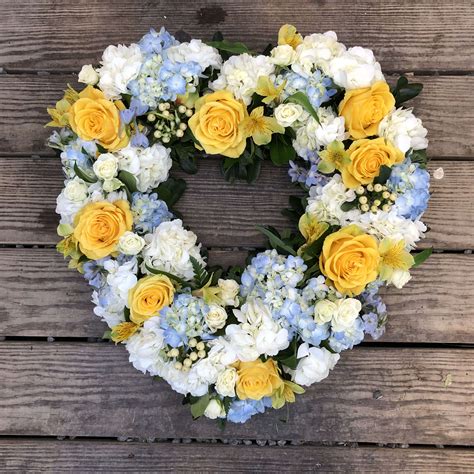 A heart shaped design is the best arrangement to send the family who had suffered a tremendous loss. Evans Blue Yellow & White Small Open Heart in Peabody, MA ...