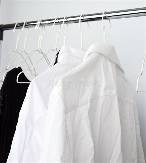 White Men S Crumpled Shirts Hanging On A Metal Hanger Stock Image