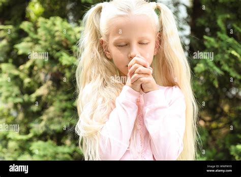 Cute Little Girl Praying Outdoors Stock Photo Alamy