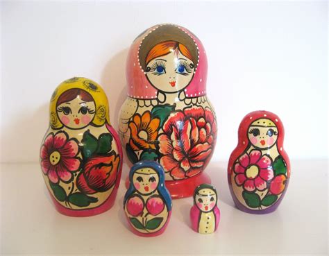 A Group Of Nesting Dolls Sitting Next To Each Other On Top Of A White Table