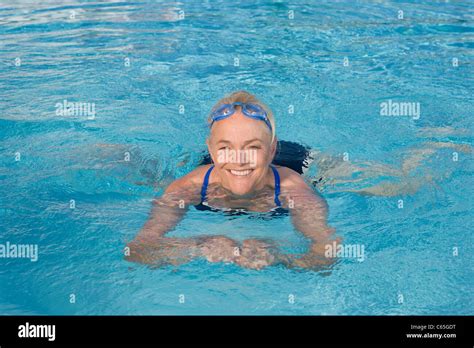 Mature Woman Swimming In Pool Stock Photo Alamy