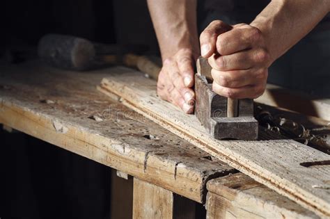 carpenter planing  plank  wood   hand plane stock