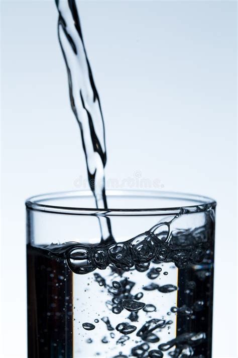 Pouring Water From A Bottle Into Glass Stock Photo Image Of Drop