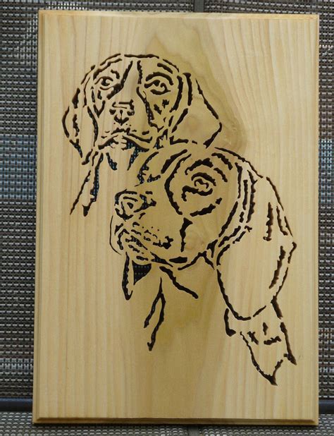 A Wooden Plaque With A Drawing Of A Dog On Its Face In Black Ink