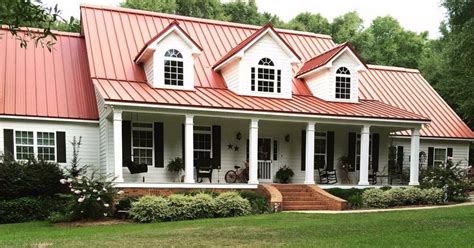 Gorgeous kitchen with white wooden cabinets, hardwood flooring and a breakfast island with dusty blue cabinet and shelves and metal chairs. Step into a charming farmhouse that exudes Southern ...