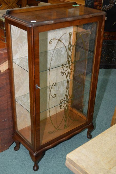 Miniature curio cabinet curved glass mahogany color wood table or wall case. Vintage English single door walnut curio cabinet with ...
