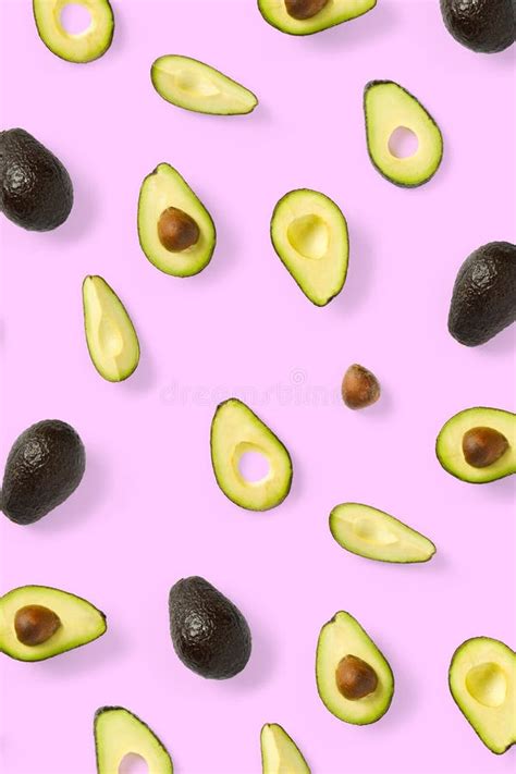 Avocado Background Made From Isolated Avocado Pieces On Pink