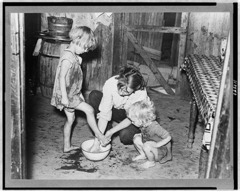 washing feet Mother washing children's feet in a ...