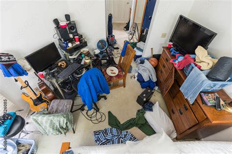 Very Messy Cluttered Suburban Teenage Boys Bedroom With Piles Of