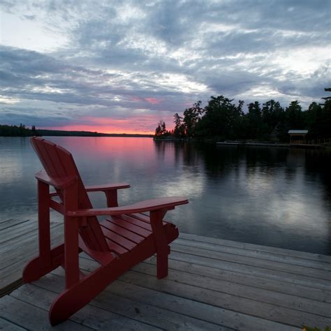 Premium Photo Muskoka Chair On The Dock At Sunset In Lake Of The