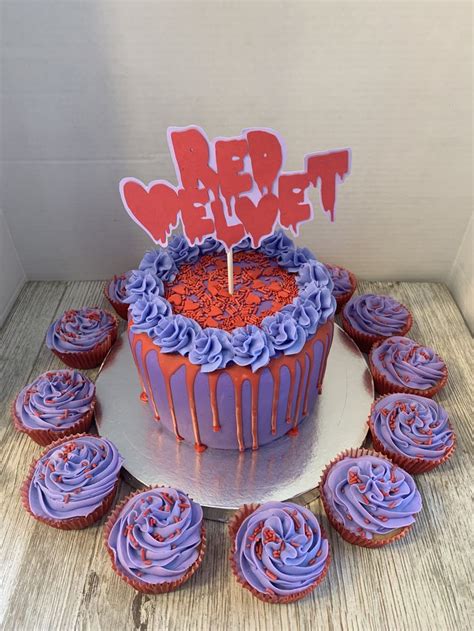 A Cake With Purple Frosting And Red Sprinkles Sits On A Plate