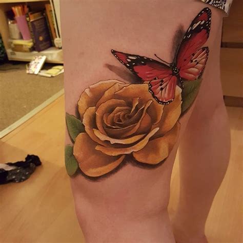 Blue and yellow butterfly tattoo. Yellow rose butterfly thigh tattoo | Butterfly thigh ...