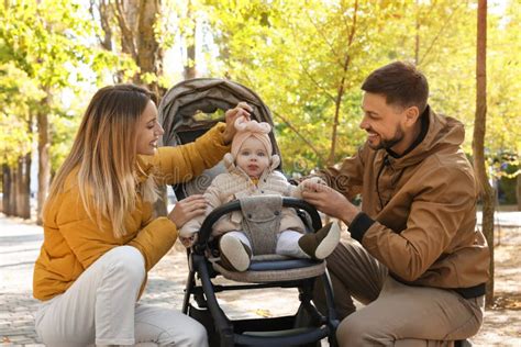 Padres Felices Con Su Bebé En Un Coche De Alquiler En El Parque En Un