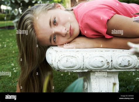Beautiful Tween Lying On Garden Bench Stock Photo Alamy