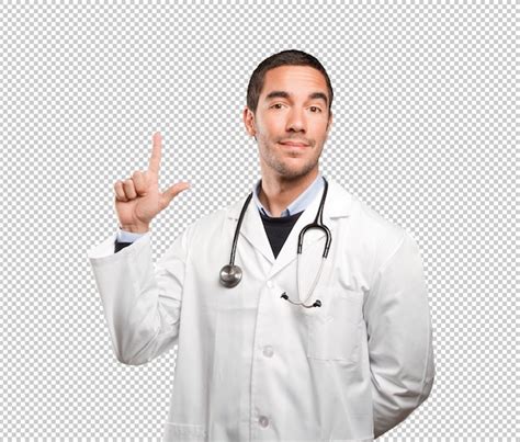 Premium Psd Happy Doctor Pointing Against White Background