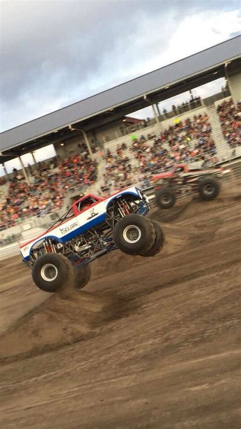 A Monster Truck Is In Mid Air During A Race