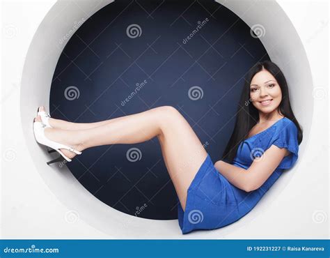 Brunette In Blue Dress Sitting In A Circle Stock Image Image Of