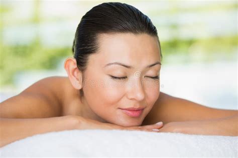 Smiling Brunette Lying On Massage Table With Eyes Closed Stock Image Image Of Young Adult