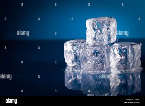 Frozen Ice Cubes On Blue Background With Reflection Stock Photo Alamy